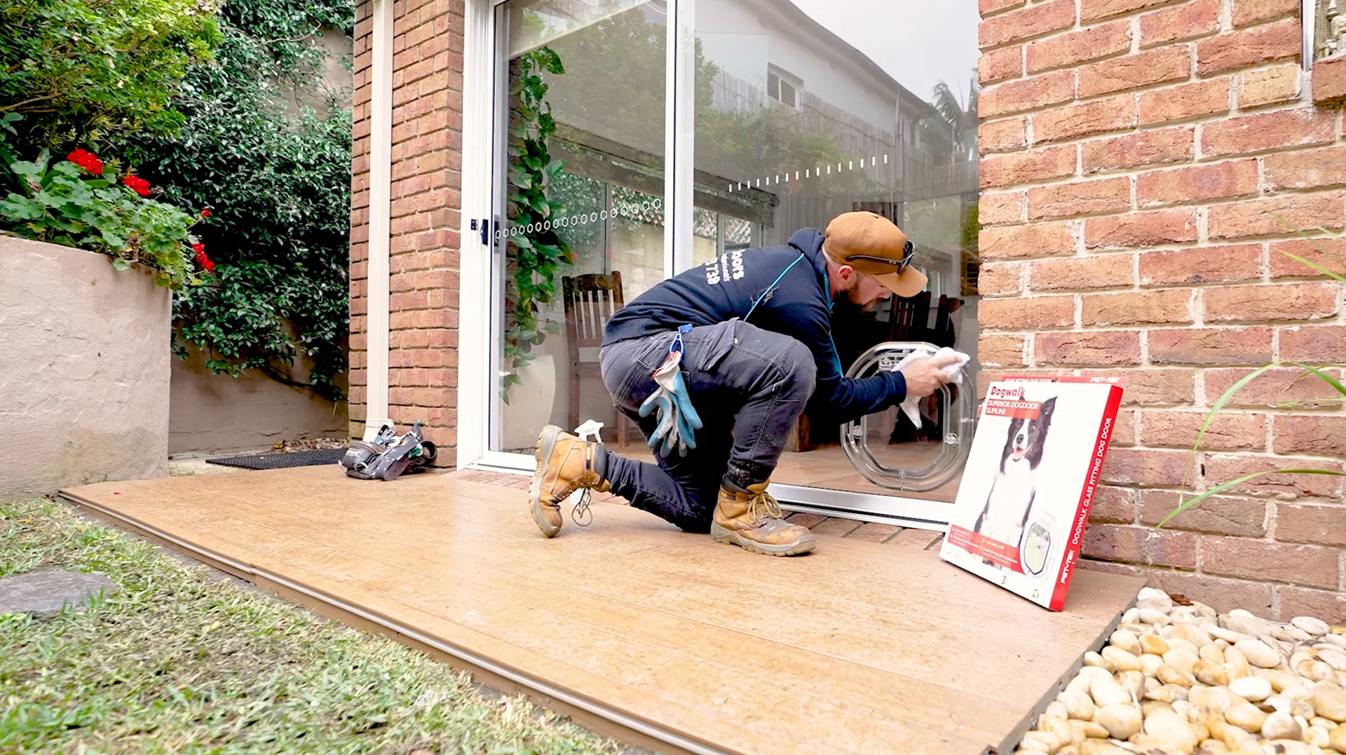 Sydney pet Door installation specialist installing a large dog door in glass door.